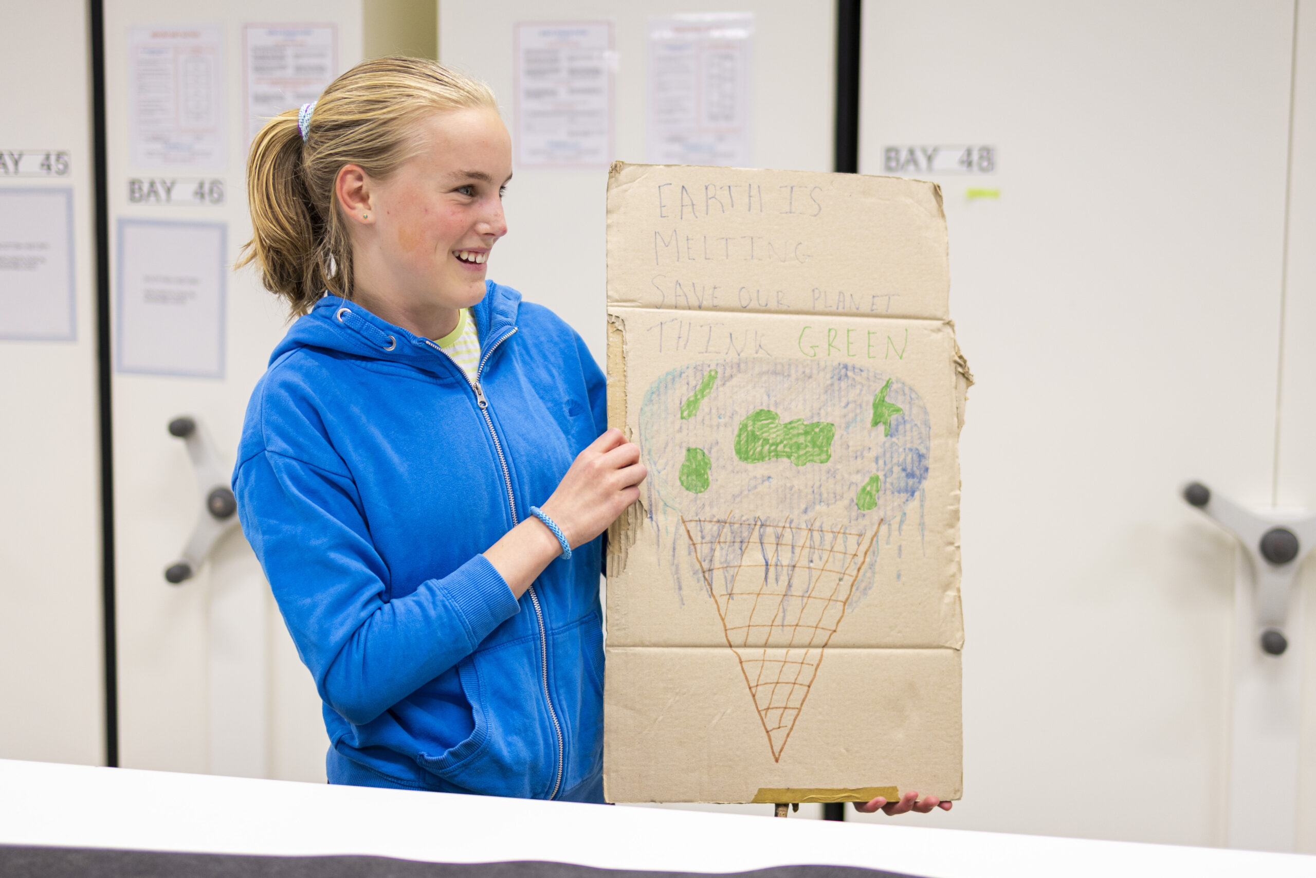 Bridget, aged 14, with her School Strike for Climate placard at the National Museums Collection Centre. Photo ©Duncan McGlynn