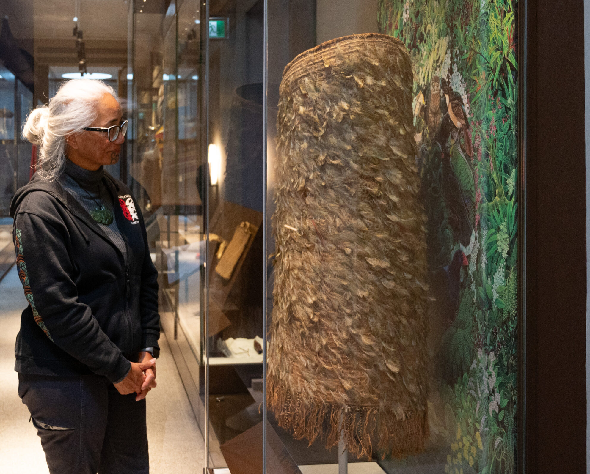 Dr Awhina Tamarapa observes the Kahu Kākāpō in Perth Museum