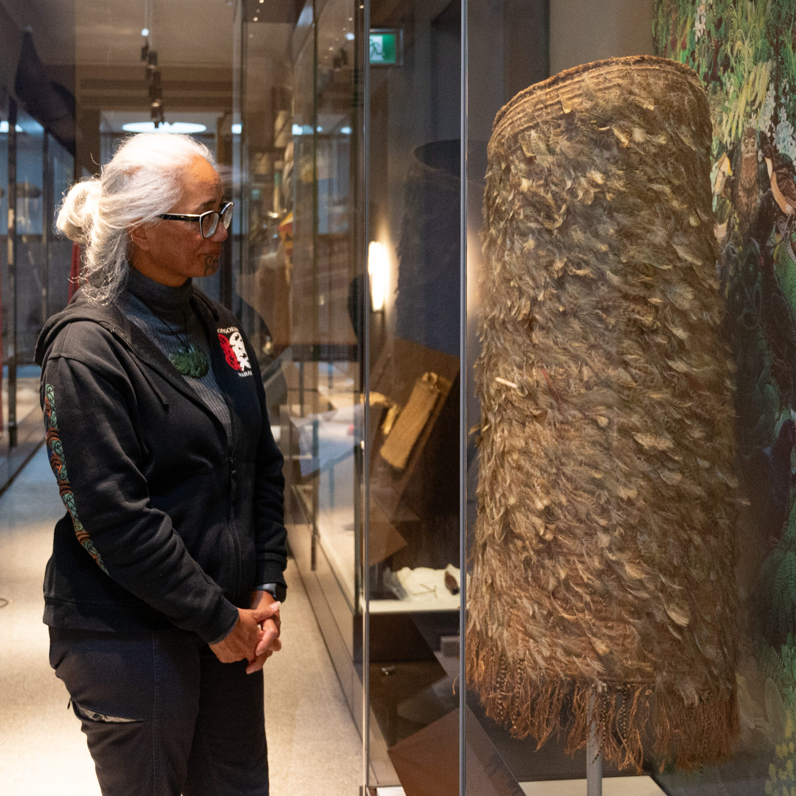 Photo-9-Dr-Awhina-Tamarapa-installing-Kakapo-Cloak-Credit-Julie-Howden-scaled-aspect-ratio-350-350